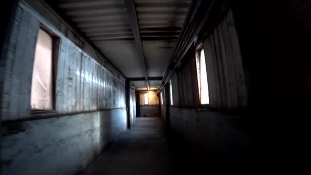 Worker walk through a dark corridor at a metallurgical plant. POV, action camera shot. — Stock Video