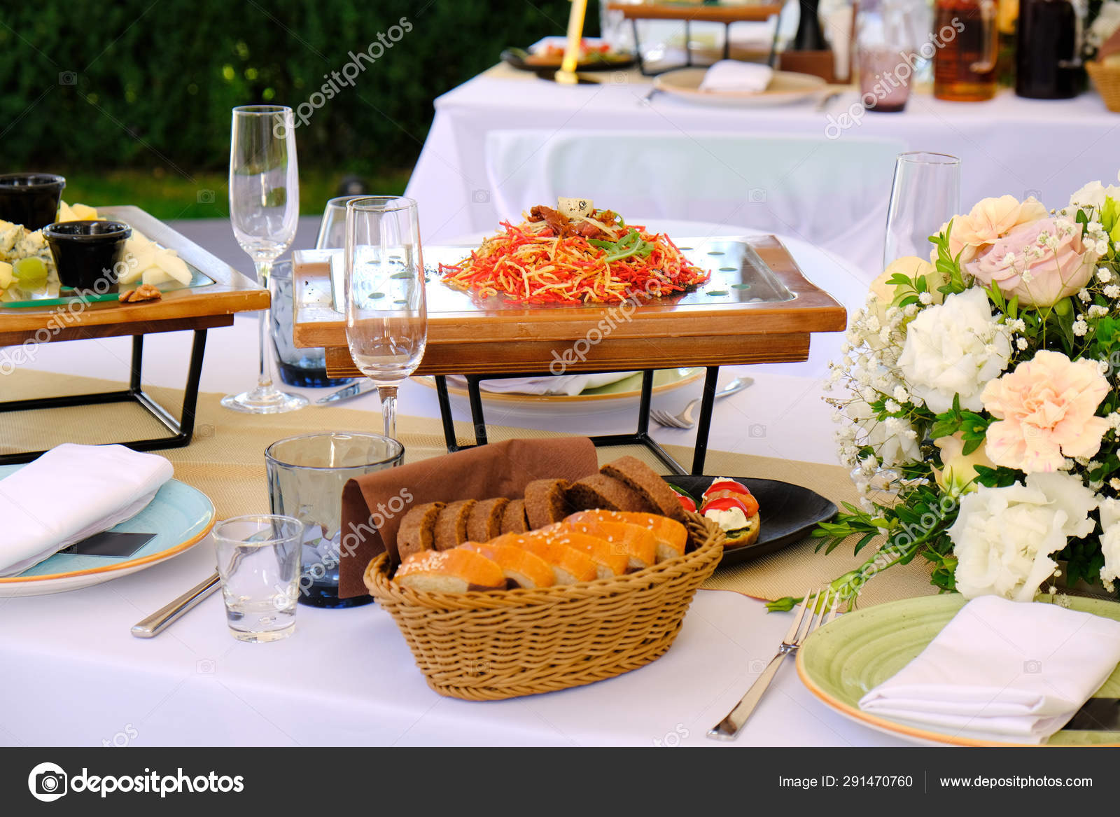 Fresh Salad On A Wooden Plate On A Banquet Table Decorated With