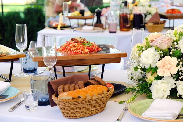 Salada fresca em uma placa de madeira em uma mesa de banquete decorada com — Fotografia de Stock