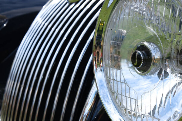 Headlights , radiator of luxury retro vintge car ckose-up. 
