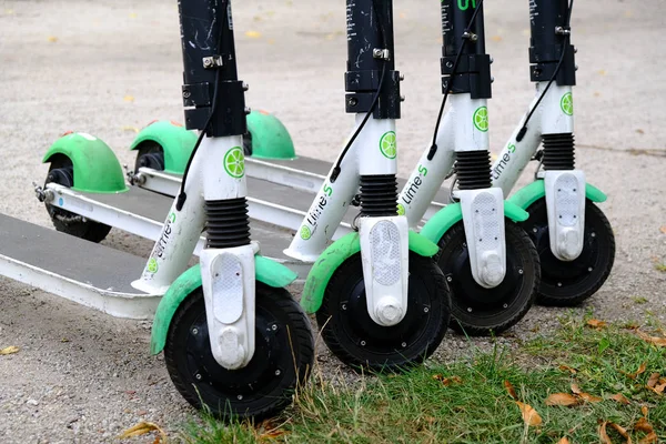 Dört elektrikli scooter Lime-S bir şehir kaldırımda üst üste park