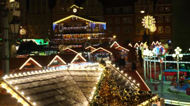 Az emberek sétálnak, körhintáznak újévi vásáron karácsonyi fények között. — Stock videók