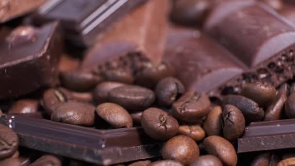 烤咖啡豆和巧克力在旋转桌子上的特写 香味浓郁的咖啡粒和甜巧克力片都在转动 — 图库视频影像
