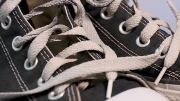 Close Van Roterende Paar Zwarte Gebruikte Sneakers Converse Met Witte — Stockvideo
