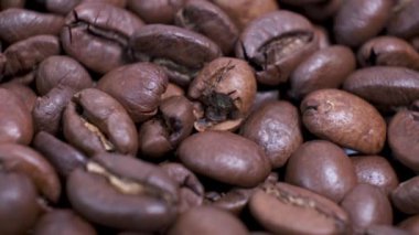 Dönen masanın üzerinde kavrulmuş kahve çekirdekleri. Aromatik kahve taneleri dönüyor..