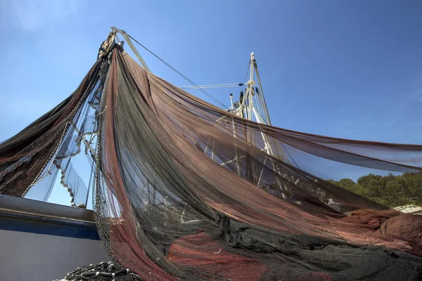 Pulling fishing net on ship before going on the sea, on island Brac in Croatia