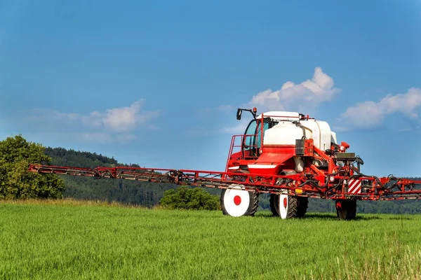 Field spraying tractor. Agricultural work on a farm in the Czech Republic. Spraying against pests