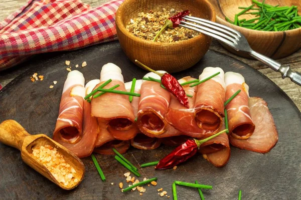 Thinly sliced German black forest ham with sliced ciabatta bread. Sliced and smoked ham with schwarzwald ham or prosciutto. Traditional German food