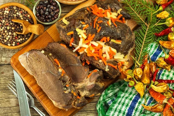 Sliced roast meat from wild boar. Pork baked in the oven. Wild game hunting.