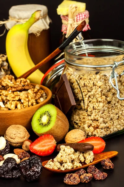 Fundo alimentar saudável com aveia caseira granola ou muesli com frutas. Muesli com nozes. Muesli em uma mesa preta. Comida para atletas . — Fotografia de Stock