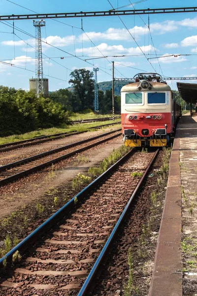 Tren en plataforma en la estación en la República Checa. Vías férreas con traviesas de hormigón. Estación ferroviaria local . — Foto de Stock