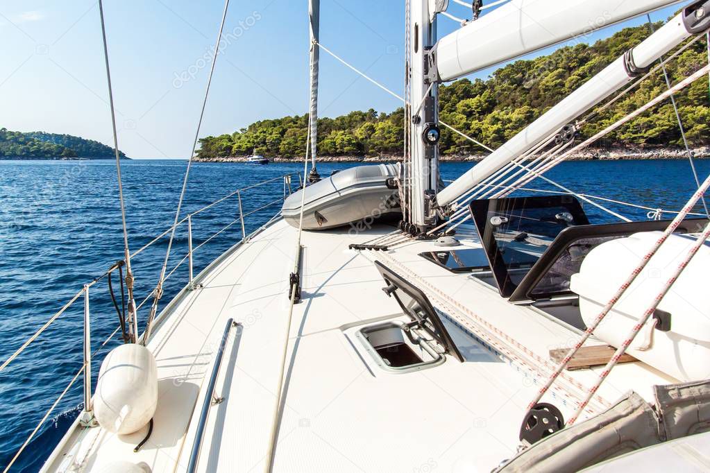 Sailing boat near Croatian island Lastovo. View from the deck of the yacht. Vacation on a boat. Sailing on the sea.