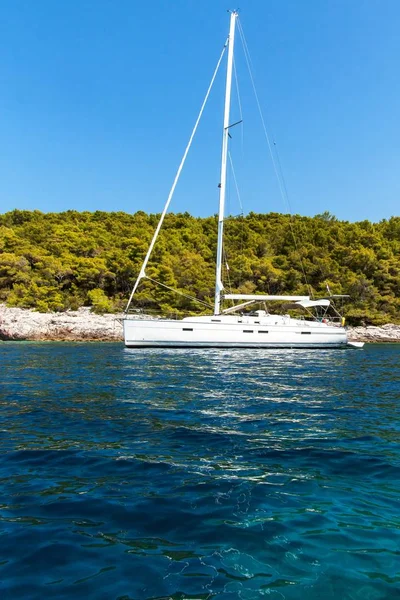 Sailing boat moored off the coast in Croatia. Sailboats moored in the bay. Yachting sport. Holiday on a sailboat.