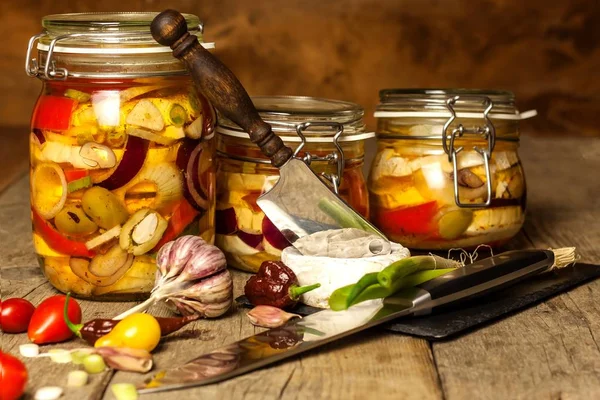 Cheese pickled in olive oil. Home-made pickled cheese. Jar with Camembert cheese marinated in oil on wooden table. — Stock Photo, Image