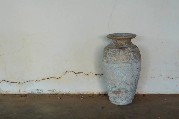 old pot vase classic / vintage vase old ceramic clay pot for flower on wall crack background