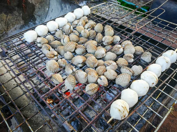 Cockle Grilled / Seafood of barbecue blood cockle cooking shellfish and meat ball on grill