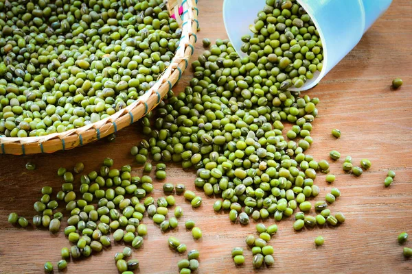 Mung beans or green beans on bamboo threshing basket with mung beans seed on background in selective focus -  for cereal whole grains food high protein