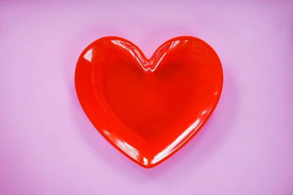 Red Heart On Pink / Valentines dinner romantic love concept - Romantic table setting decorated with red heart plate on pink background