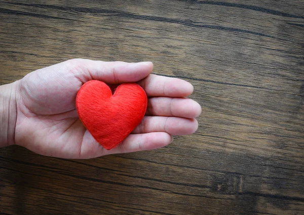 Give Love Man Holding Red Heart In Hands For Love Valentines Day Donate Help Give Love Warmth Take Care Concept On Wooden Table Rustic Background Stock Images Page Everypixel