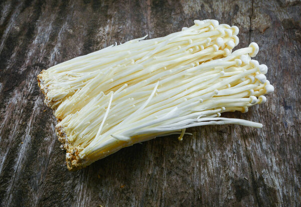 Golden Needle Mushroom - Enoki / Fresh golden needle mushroom from the farm on wooden background