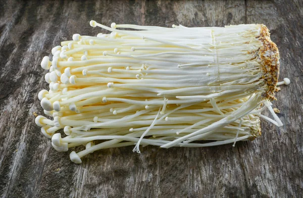 Golden Needle Mushroom - Enoki / Fresh golden needle mushroom from the farm on wooden background