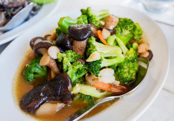 broccoli cooked shiitake mushrooms / stir fried shrimp broccoli vegetable with oyster sauce mushrooms on white plate