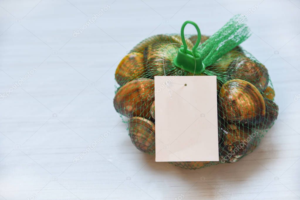 Shellfish enamel venus shell Seafood Clams on net bag in the supermarket