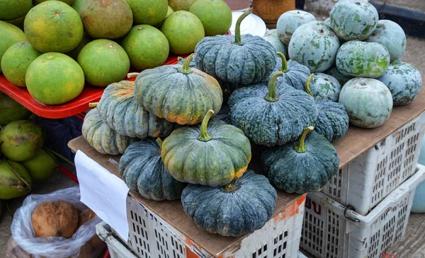 Green pumpkin winter melon and pomelo fruit for sale in the market