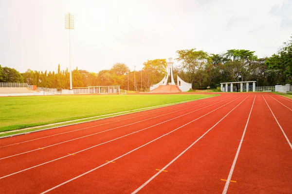 Athletics Track Run / Red running track in stadium with green field with white line in sports outdoor on stadium