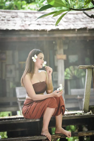 Asia woman thai drama style dress and Sniffing flowers / Portrai — Stock Photo, Image