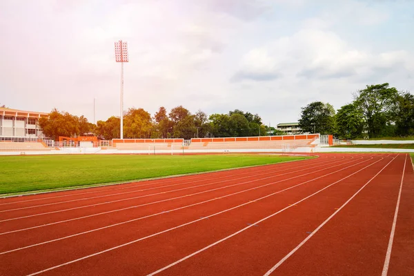 Athletics Track Run / Red running track in stadium with green fi