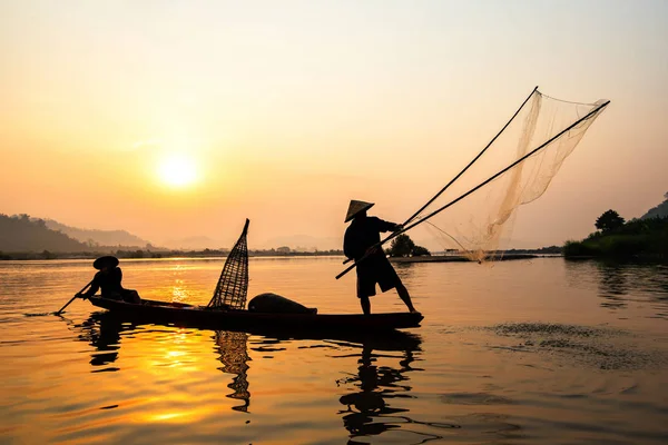 Asia fisherman net using on wooden boat casting net sunset or su — Stock Photo, Image