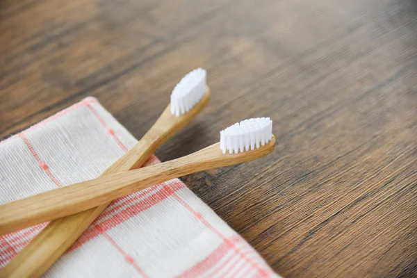 Bamboo toothbrush on the fabric eco natural plastic free items o — Stock Photo, Image