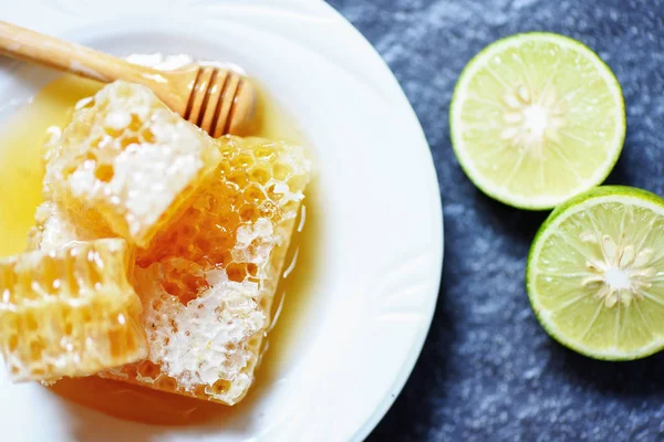 Fresh honey and lemon lime / Close up of yellow sweet honeycomb — Stock Photo, Image