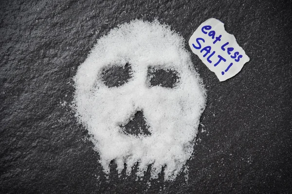 Eat less salt for health concept / Heap of white salt skull shap — Stock Photo, Image