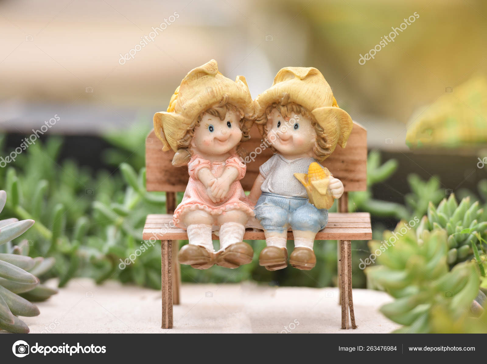 Little couple doll cute sitting on wooden bench decorate the gar ...
