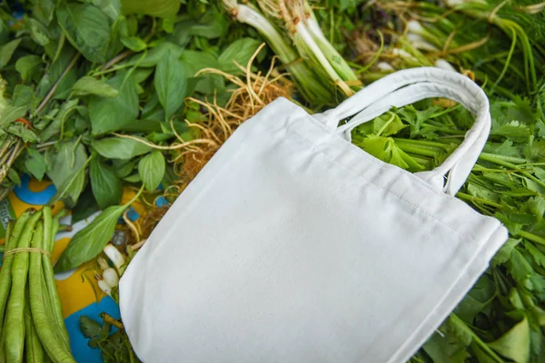 Eco cotton fabric bag on fresh vegetables in the market free pla