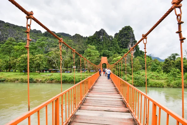 Tourists walking on orange bridge and mountain background on son Stock Photo