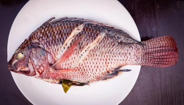 fish steam herb and Vegetable on plate / Steamed tilapia fish