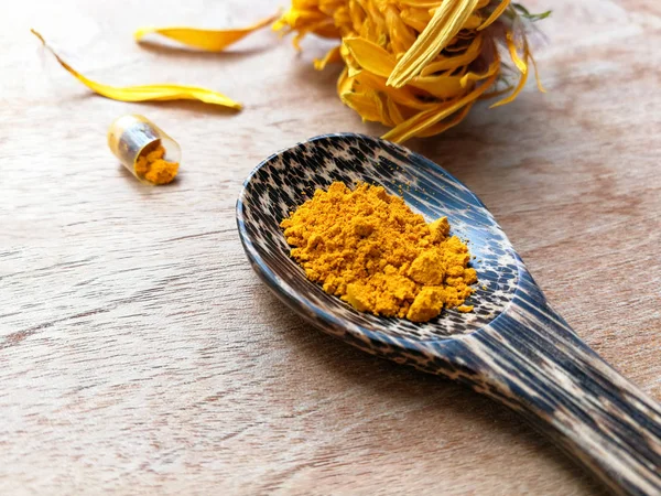 Turmeric powder natural herbs on wooden spoon with capsule and y — Stock Photo, Image