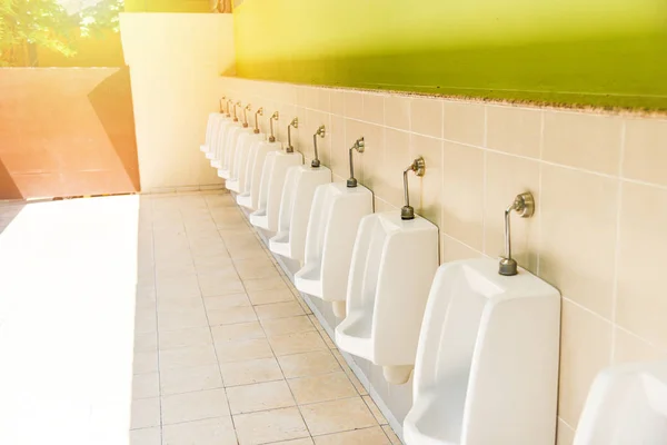 Row of urinal toilet blocks for man on tiled wall — Stock Photo, Image