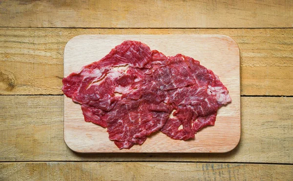 Rebanada de carne de res en tabla de cortar de madera para cocinar o Sukiyaki S —  Fotos de Stock