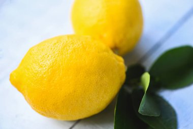 Masa arka plan üzerinde yeşil yaprakları ile Taze limon 