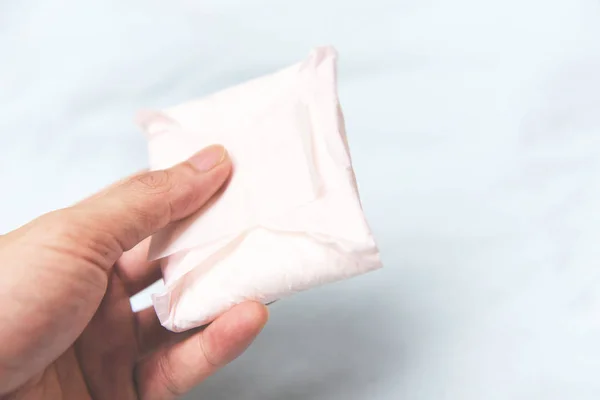 Holding Sanitary napkin or feminine sanitary pad on hand - Femal