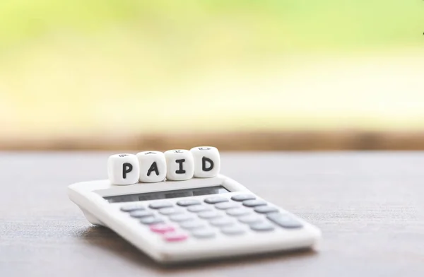 Paid words and calculator on table for time paid payment at offi — Stock Photo, Image