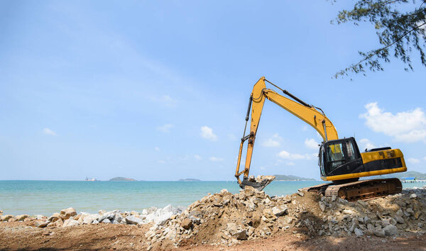 excavator digger stone working on construction site - backhoe lo