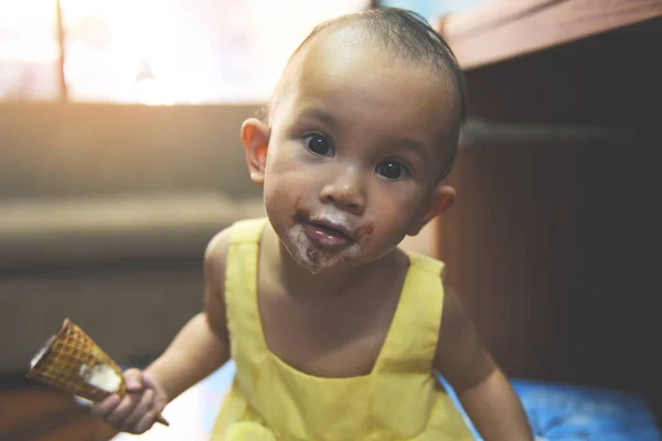 Child eating ice cream - Funny Asian baby girl happy holding ice — Stock Photo, Image