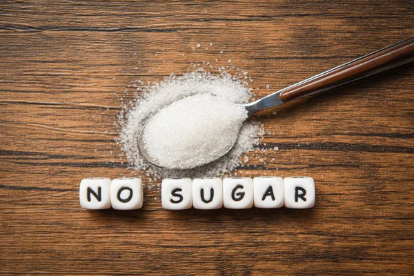 No sugar text blocks with white sugar on spoon wooden background