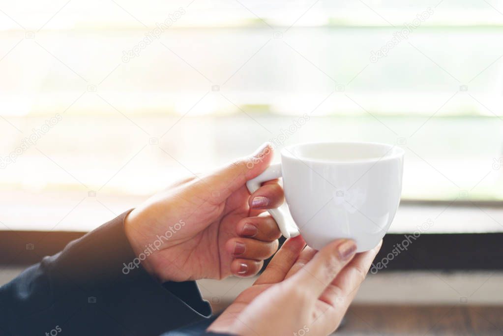 White coffee cup in hand / Business woman holding coffee cup by 