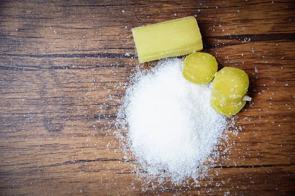 Rustik ahşap arka planda şeker kamışı ve beyaz şeker — Stok fotoğraf